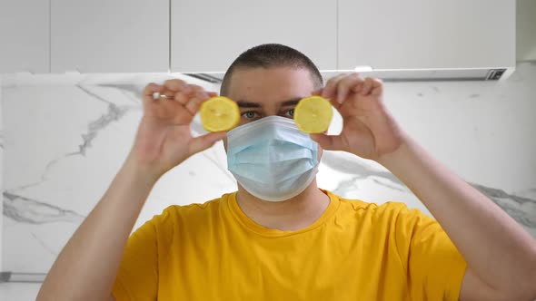 Man Wearing Medical Mask Hide Eyes with Lemon. Covid-19 Quarantine