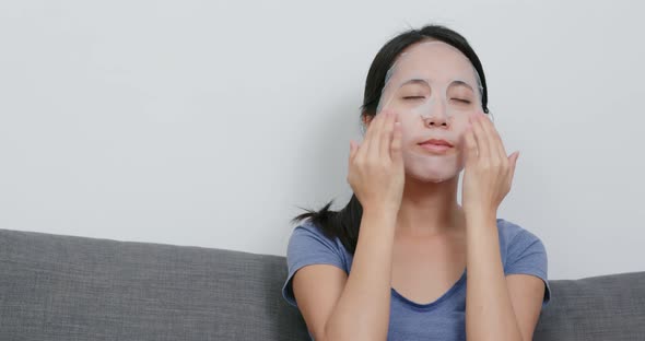 Asian Woman apply paper mask on face