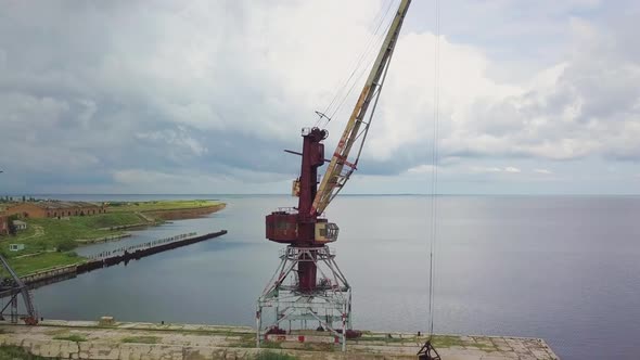 An Old Abandoned Rusty Crane in the Seaport