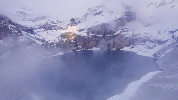 Oeschinen Lake in the Snowy Mountains of Switzerland on a Foggy Morning