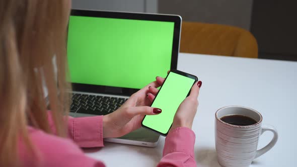 Close Up Woman Using Smartphone Green Screen on the Table with Laptop Computer Chromakey