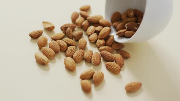 Video of almonds in a bowl on white background