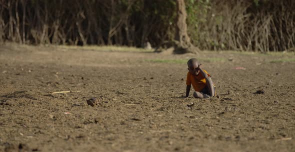 African child sitting on the ground