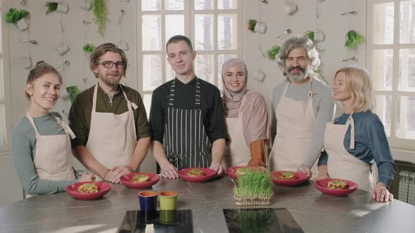 Portrait Of Chef With Students After Cooking Class