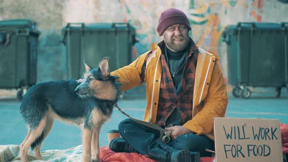 Trash Bins with a Homeless Man and His Dog Nearby