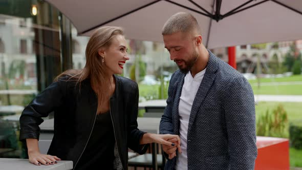 Sexy Bearded Man is Hugging His Girlfriend in Cafe Embrace on Open Terrace