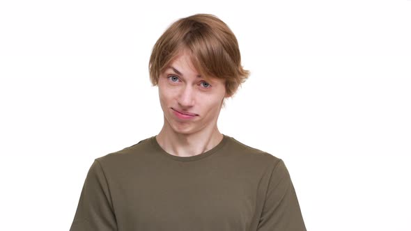 Portrait of Young Kind Man in Green Tshirt Nodding in Agreement Looking on Camera with Smile Meaning