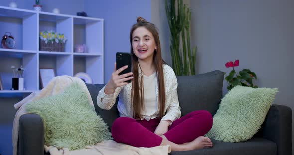 Smiling Vlogger Girl Looking at Mobile Make Video Call Shooting Vlog Taking Selfie