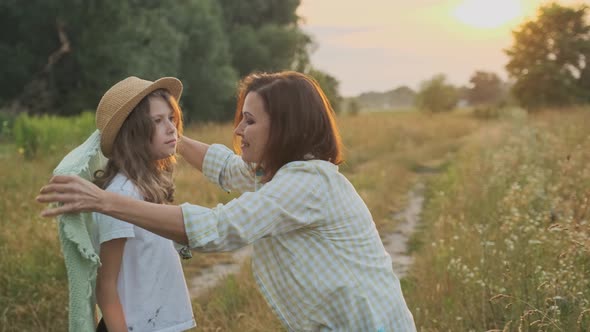 Loving Moms Puts on Daughter Knitted Blanket