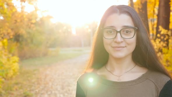 Beautiful Girl Looking at the Camera and Smiling