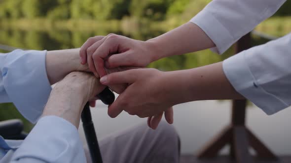 Close Up View of Man's Hands and Nurse's Hands