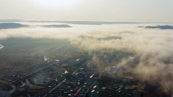 Flight Over the Valley Covered with Morning Mist in the Countryside