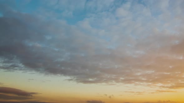 Time Lapse with Fast Moving Clouds on Blue Sky at Sunset