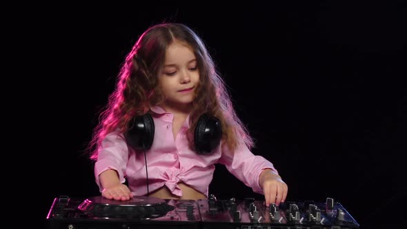 Sweet Girl Plays on Dj Console. Black Background, Slow Motion