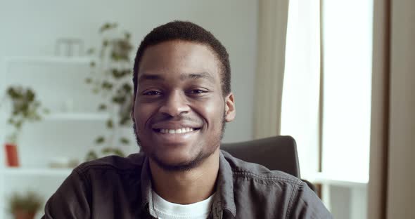 Portrait of Smiling Black Male African Guy Businessman Student Sitting at Table in Office at Home