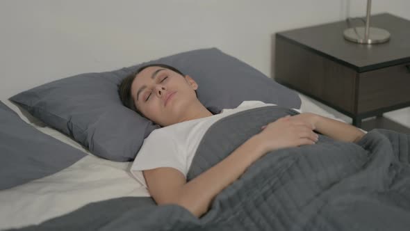 Relaxed Hispanic Woman Sleeping in Bed Peacefully