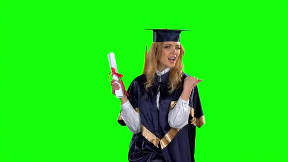 Woman in Graduation Gown Holding Diploma. Green Screen. Slow Motion