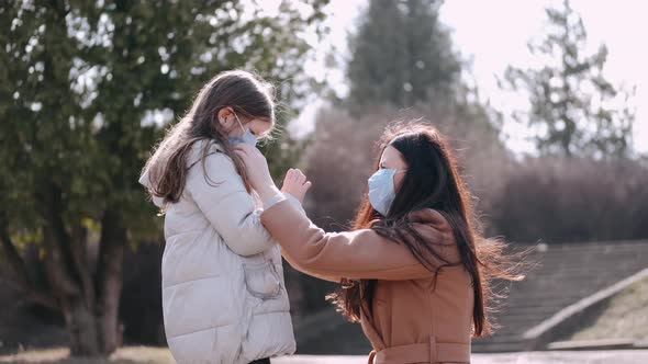 Mother and Daughter Are Wearing Disposable Masks