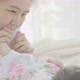 Asian Mother playing with her adorable newborn baby. - VideoHive Item for Sale