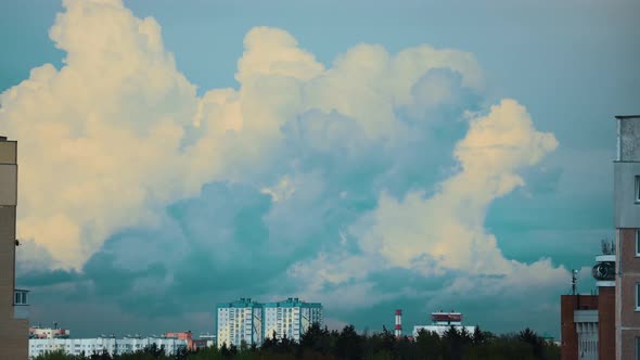Cloudy Rainy Sky With Fluffy Rain Clouds In Motion Above Multistorey Residential Houses