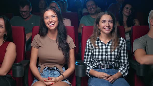 Laughing Woman Friends Watching Comedy Film Funny Scene Sitting on Armchair Audience at Cinema