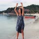 Young Woman Dancing Enjoying Vacation Travel on Tropical Beach - VideoHive Item for Sale