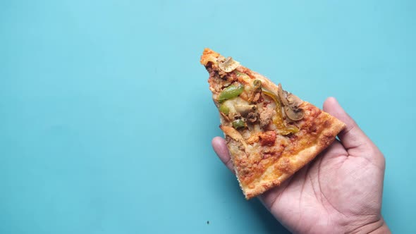 Holding Cheese Pizza on Blue Background