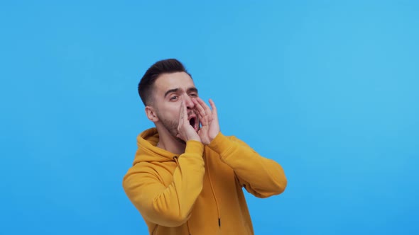 Expressive young man screaming and shouting over vibrant background.