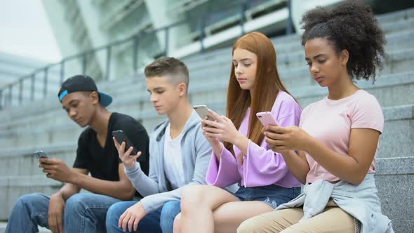 Multiethnic Teenage Friends Using Smartphone Together, Lack of Communication