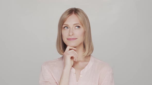 Studio portrait of young, beautiful and natural blond woman.