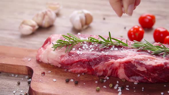 Raw Fresh Meat Steak with Herbs and Spices on Rustic Background