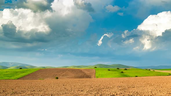 Clouds Over Plowed Fields Spring in Sunny Weather