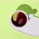 Drinking of black tea with lime from a teacup on a green background. Stop motion animation. - VideoHive Item for Sale