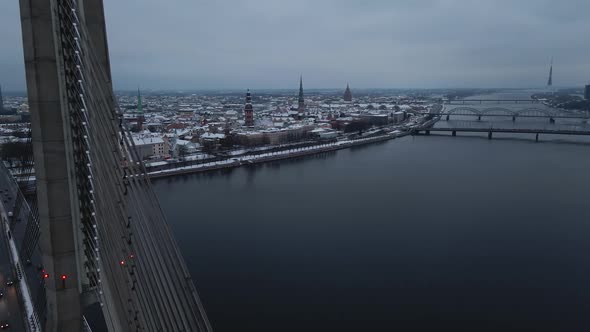 Aerial Revealing Shot of Gloomy Winter City of Riga Latvia Through Vansu Bridge