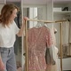 Mom Plays in Dressing Room with Twin Daughters Through Dresses - VideoHive Item for Sale