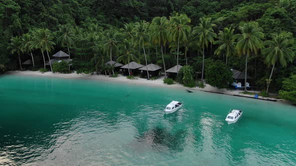 Boats Near Ocean Beach With Huts Among Palm Trees In Triton Bay, Raja Ampat. 