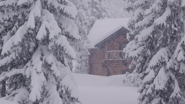 Slow Camera Pan Over a Rustic House During a Snow Blizzard in the Mountains