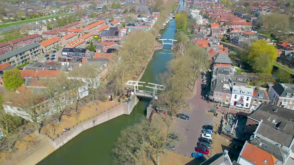 Tilt down aerial view of foot bridge over canal, Vreeswijk, Utrecht