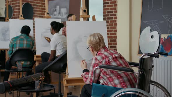 Senior Woman in Wheelchair Drawing Vase Sketch with Pencil