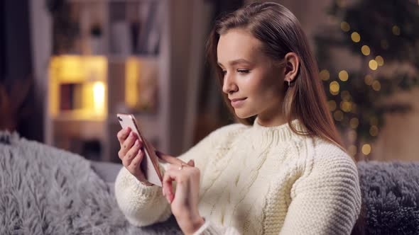 Relaxed Woman Using Smartphone at Home