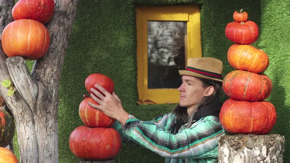 Man decorates house with pumpkins