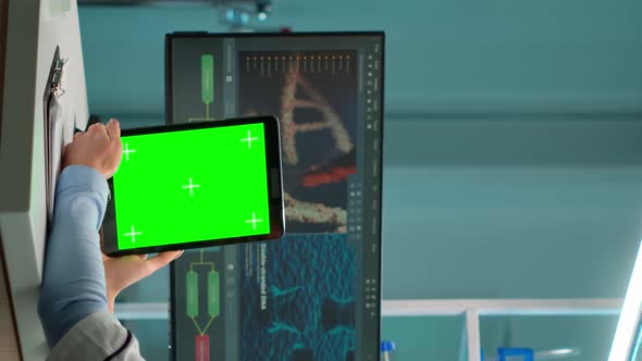 Vertical Video Chemist Scientist Using Green Mockup Screen Tablet Sitting at Desk