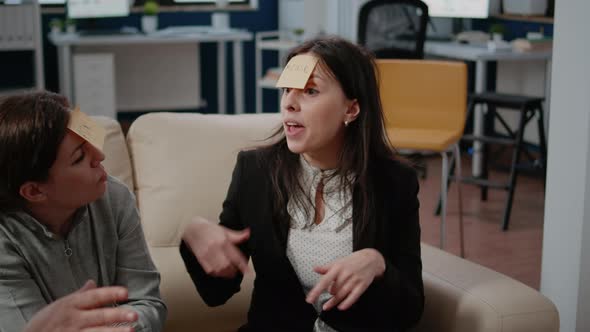 Close Up of Workmates Enjoying Game to Guess with Sticky Notes