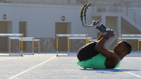 Disabled athletic exercising on a running track 4k