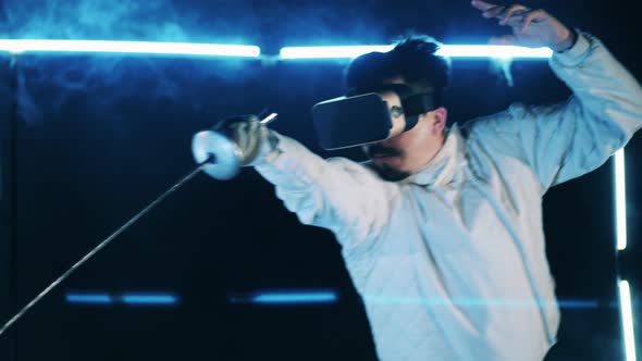 Male Athlete is Wearing VRglasses and Practicing Fencing