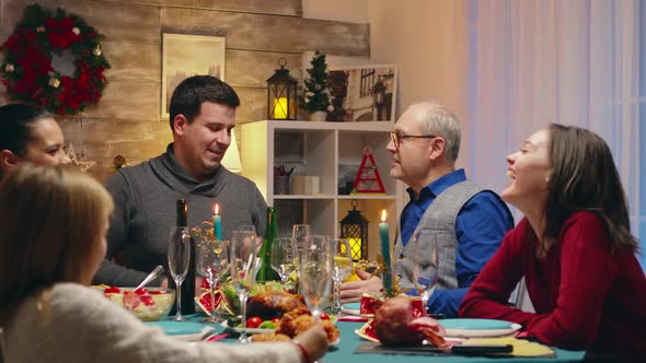 Adult Man Pouring Champagne for His Father