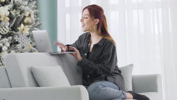 Side View of Positive Young Caucasian Woman Greeting Someone in Wireless Chat. Portrait of Happy