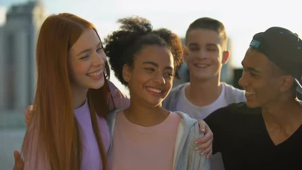 Multi-Ethnic High School Pupils Smiling Camera, Hugging Friends Togetherness