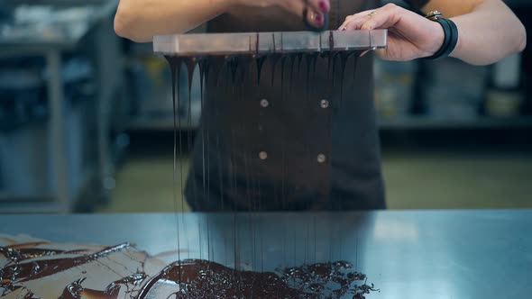 Girl Strains Chocolate Glaze Through Special Fine Sieve