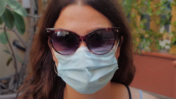 Pandemic Portrait of a Young Tourist Woman Wearing Protective Mask and Eyeglasses on Street